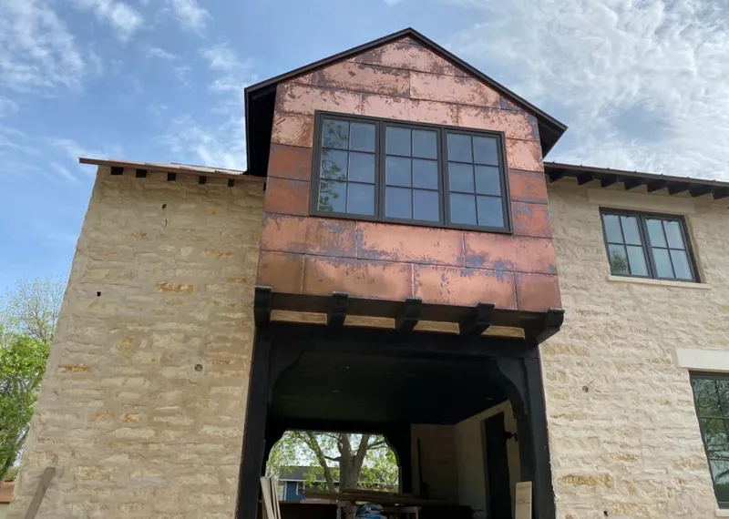 Copper metal panel facade on a stone building for Roof Repair in Halfmoon